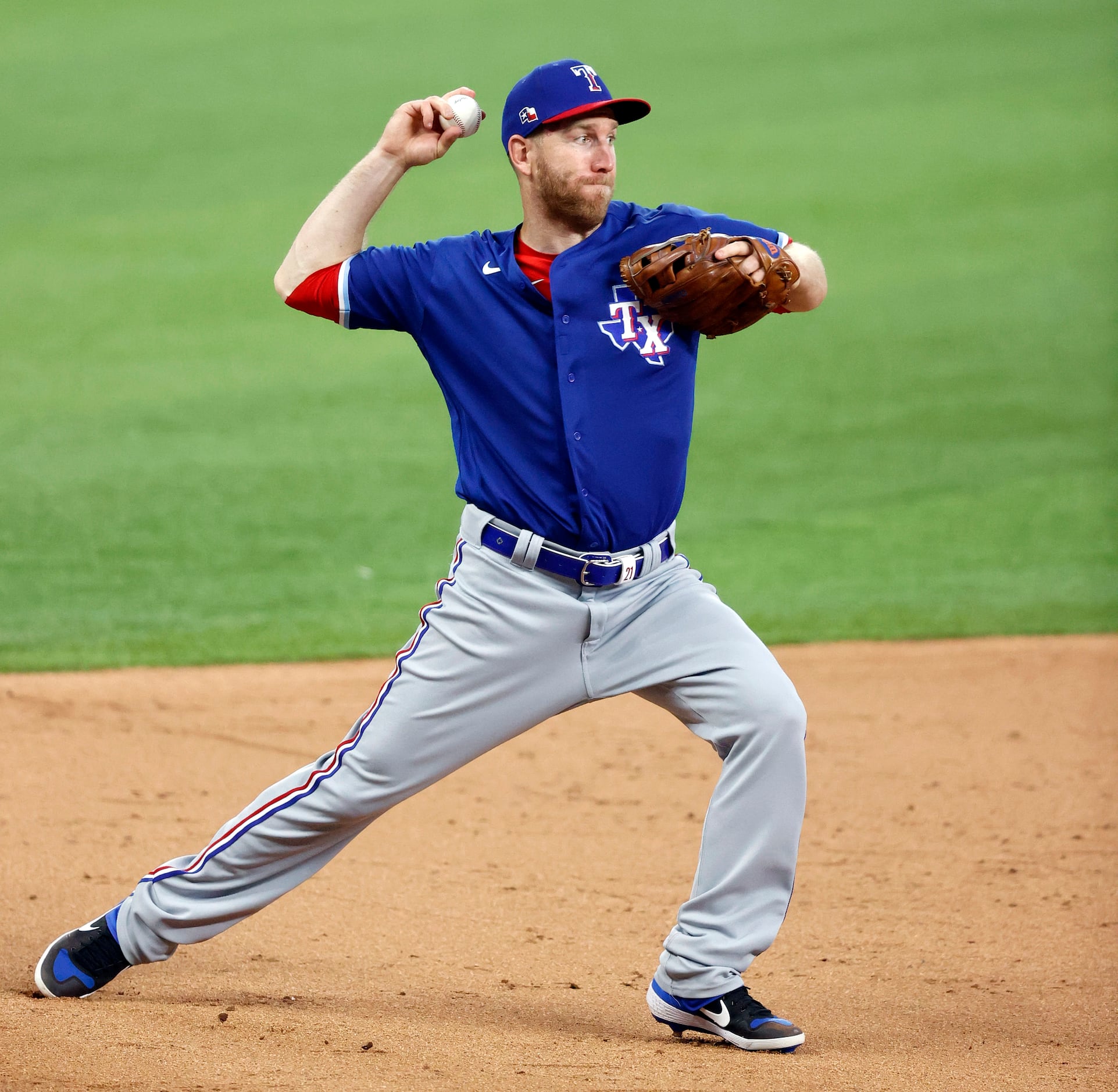 Texas Rangers third baseman Todd Frazier fields an infield ball and makes the play at first...