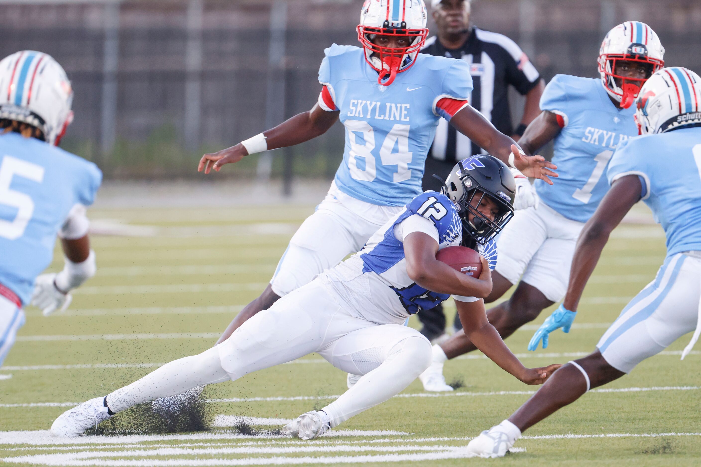 North Forney High’s Michael Douglas (12) runs with the ball for the first down against...