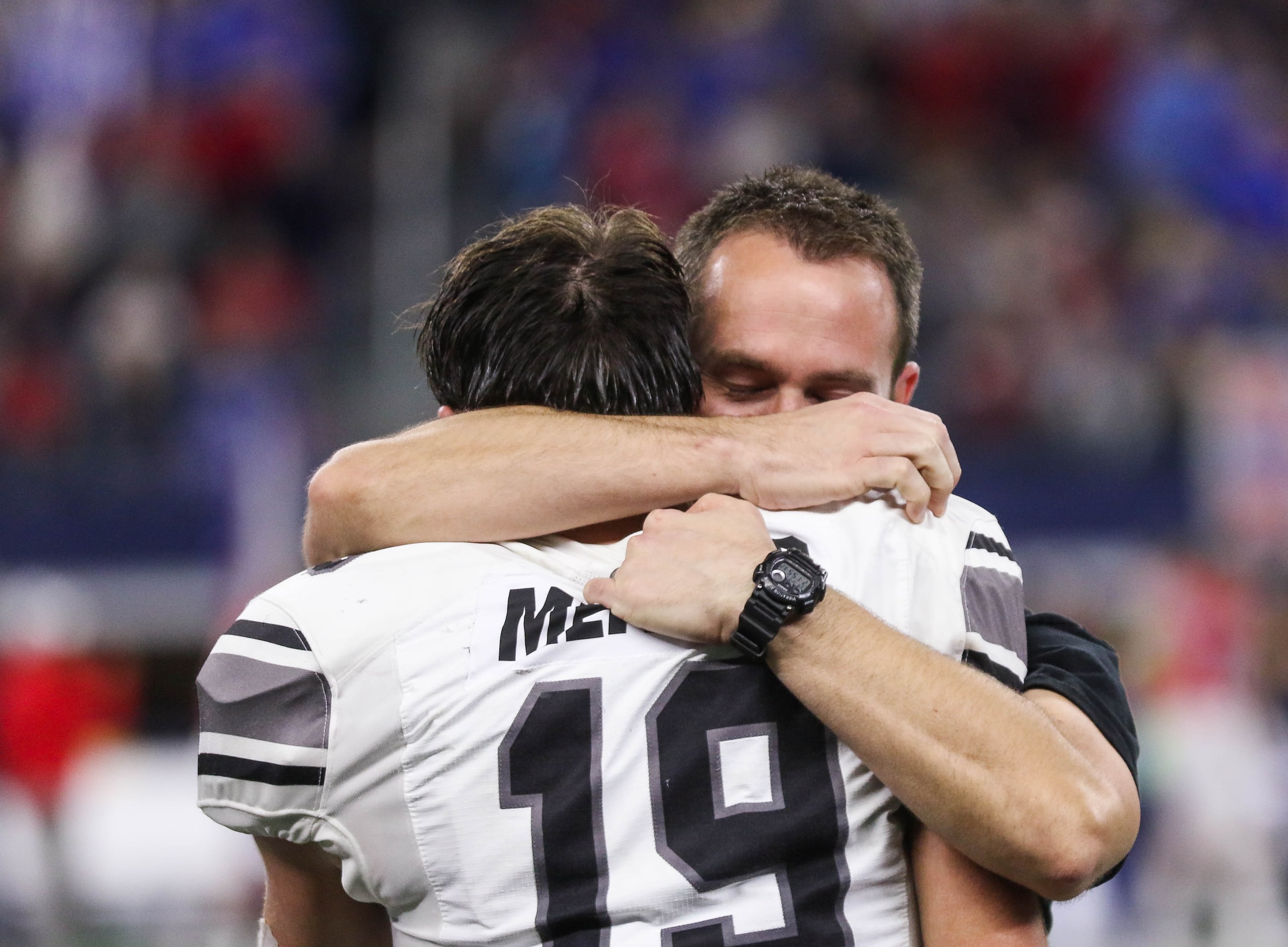 A Denton Guyer coach hugs player Seth Meador (19) in the fourth quarter of a Class 6A...