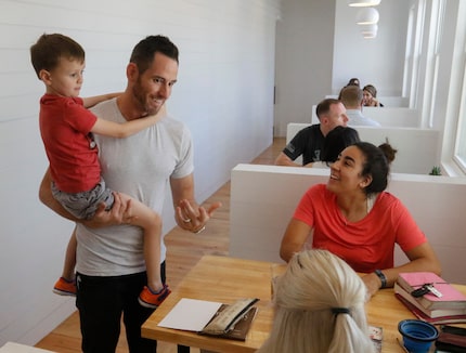 Jett Hemberger, 5, and his dad, Christian Hemberger, visit with customers at George coffee...