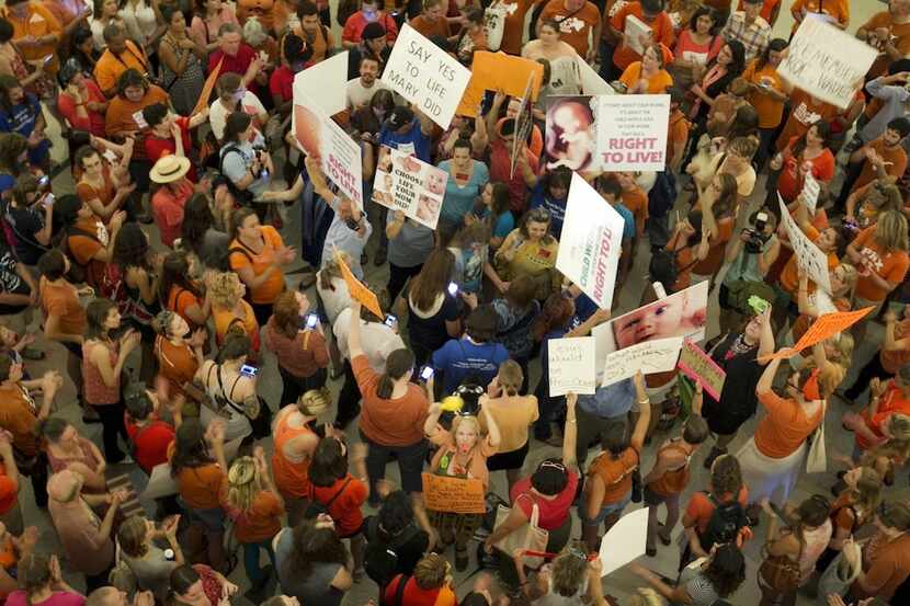  People on both sides of the abortion debate gather during the Senate's debate on Friday...