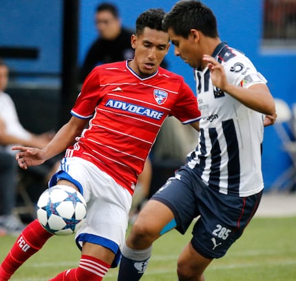 FC Dallas player Jesus Ferreira Castro (7) plays the soccer ball while defended by CF...