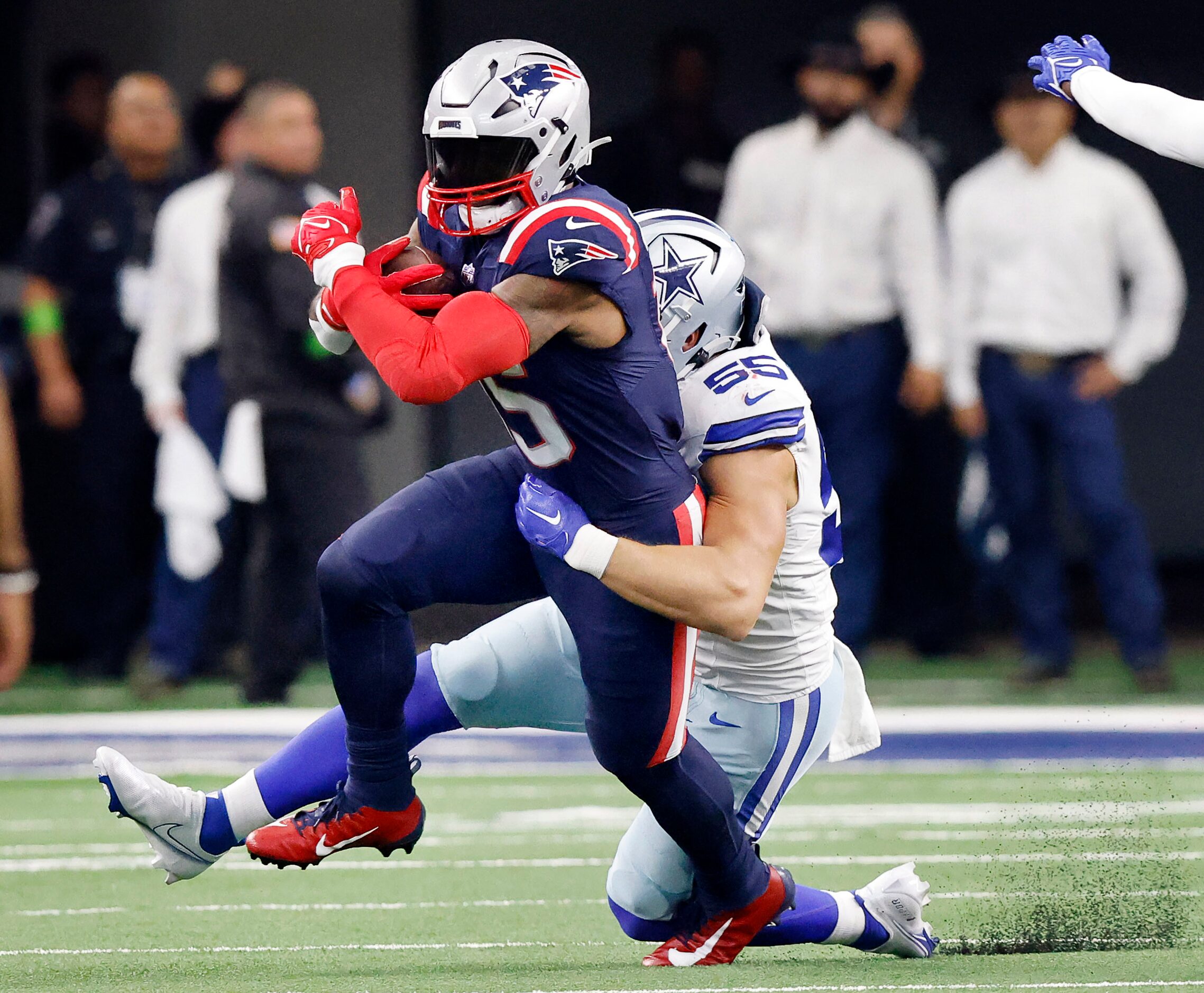 New England Patriots running back Ezekiel Elliott (15) is taken down by Dallas Cowboys...