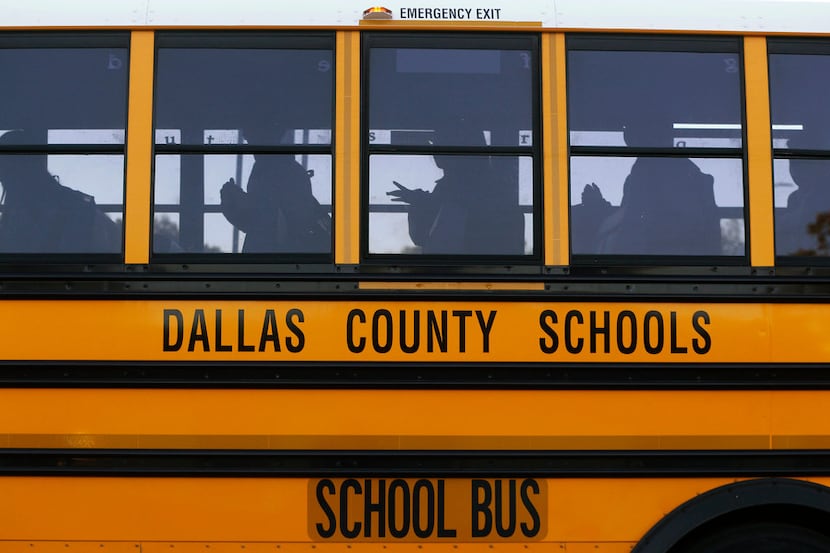 Buses drop students off at W.E. Greiner Exploratory Arts Academy in Dallas on Oct. 25.