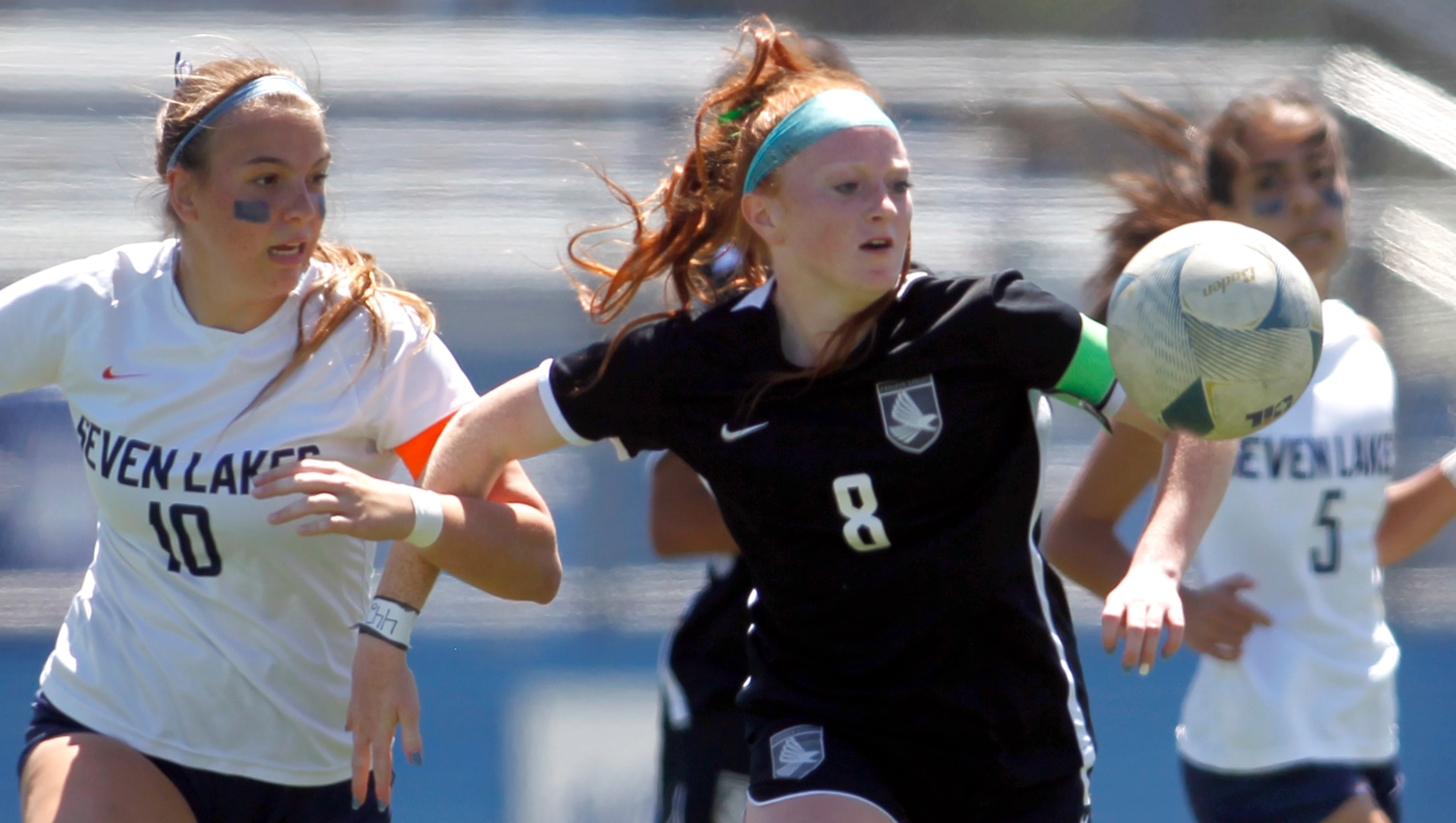 Prosper midfielder Olivia Hess (8), center, eyes the ball as Katy Seven Lakes midfielder...