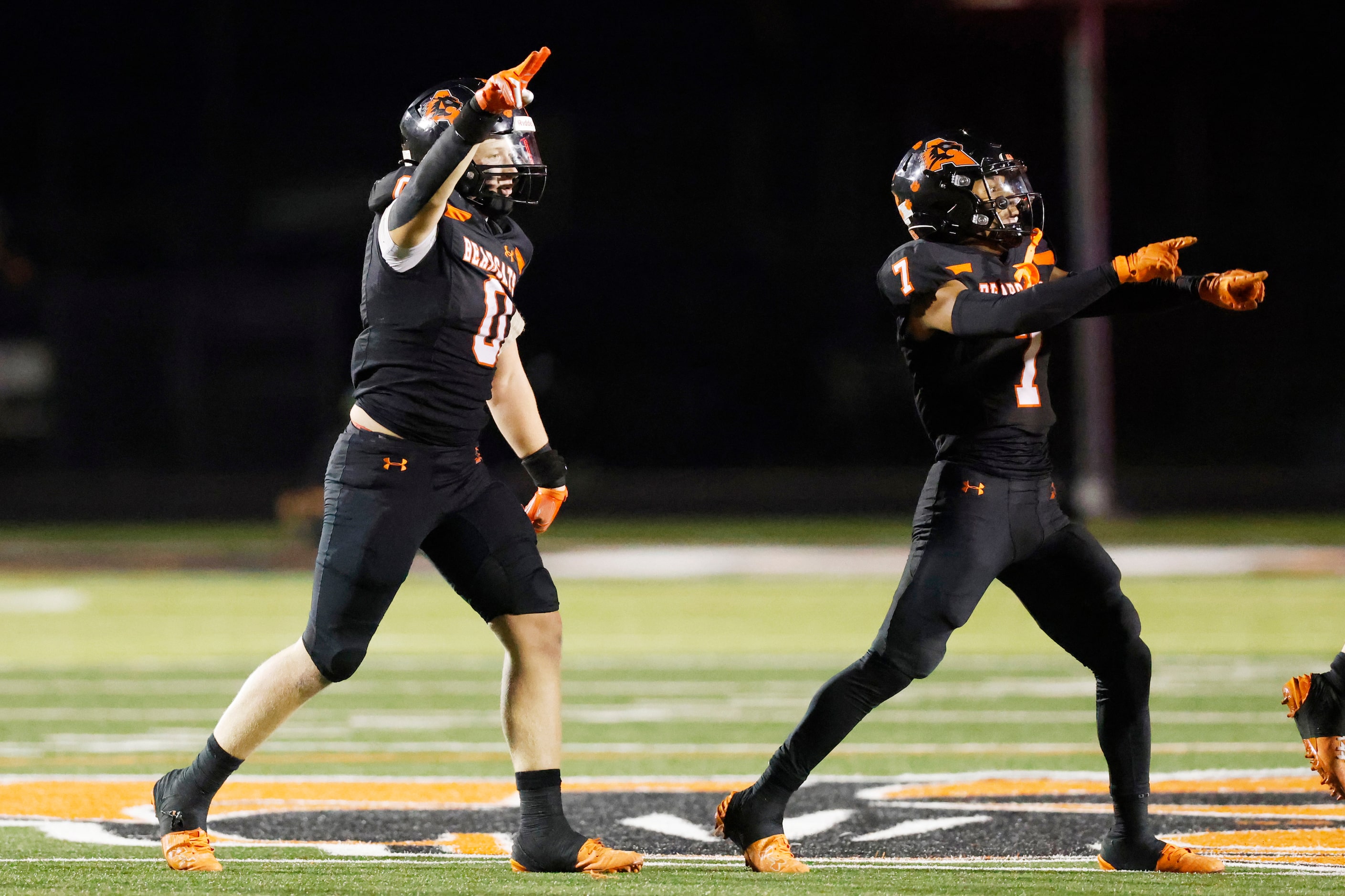 Aledo linebacker Owen Henderson (0) celebrates after intercepting the ball alongside...