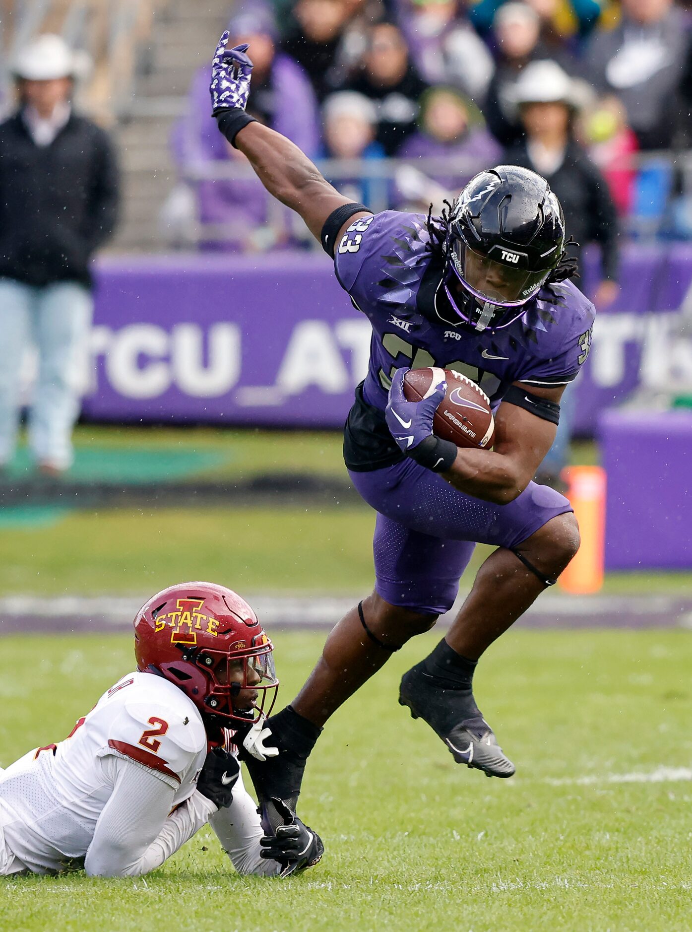 TCU Horned Frogs running back Kendre Miller (33) escapes the tackle attempt by Iowa State...