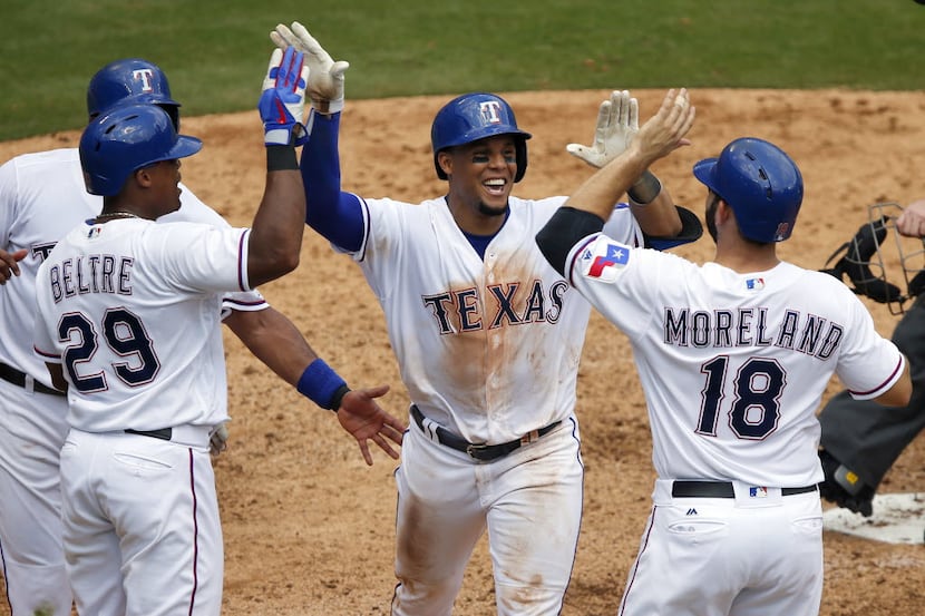 Texas Rangers left fielder Carlos Gomez (upper right) is congratulated on his fourth inning...