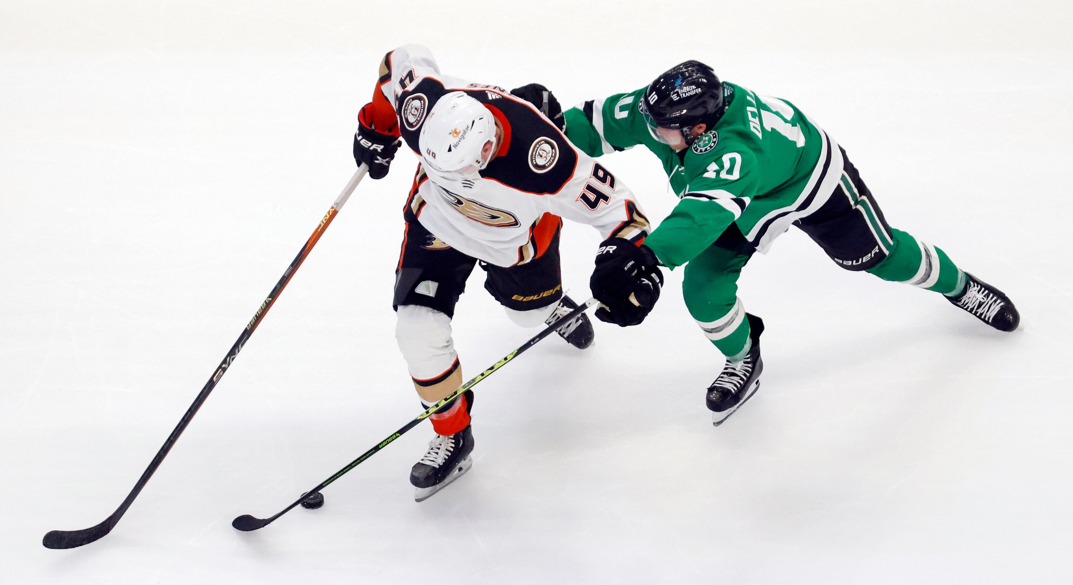 Dallas Stars center Ty Dellandrea (10) battles Anaheim Ducks left wing Max Jones (49) for...