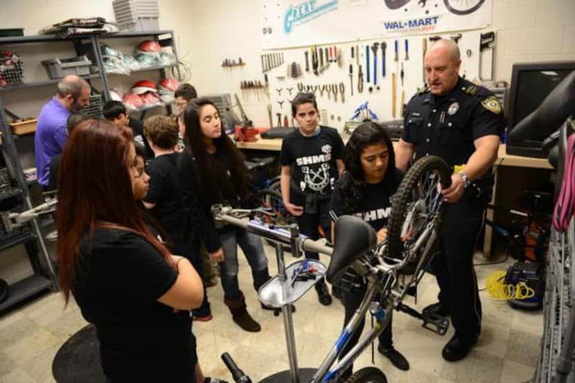 
Students in Garland ISD's after-school program repair bicycles work together.
