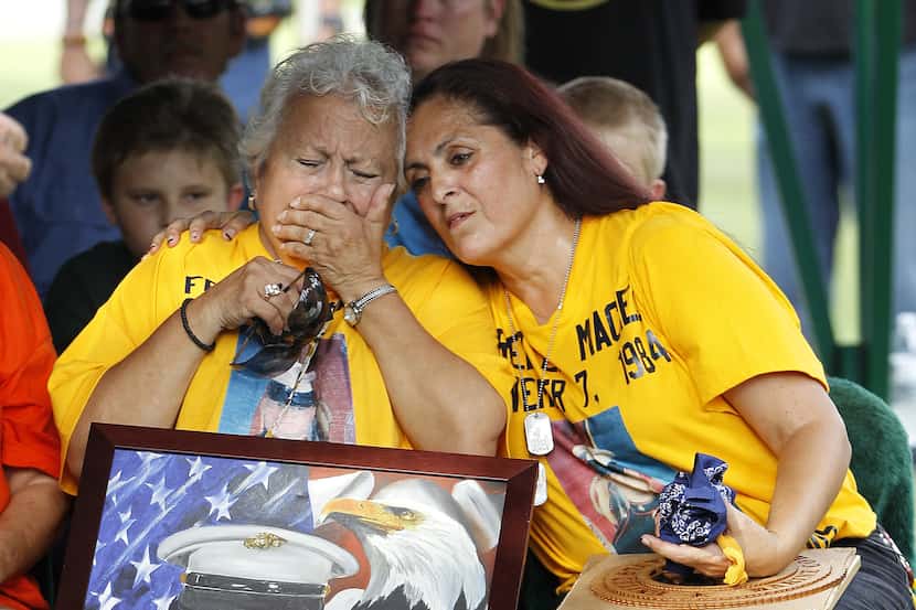Hope Dorris, left, is comforted by her daughter, Patsy Maciel, the mother of Lance Cpl. Fred...