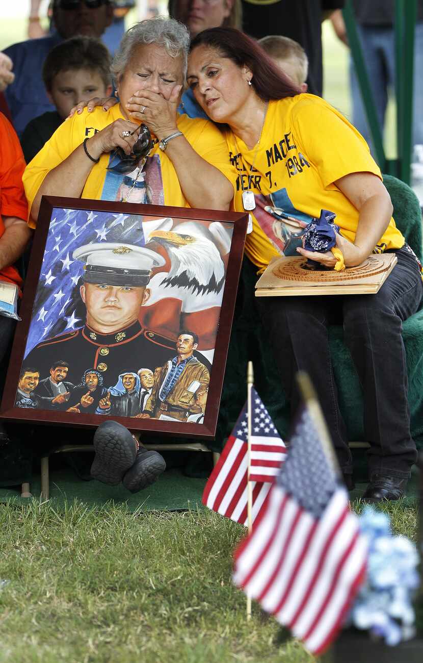 Hope Dorris, left, is comforted by her daughter, Patsy Maciel, the mother of Lance Cpl. Fred...