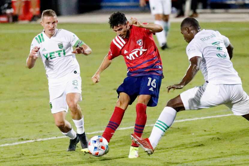 FC Dallas forward Ricardo Pepi (16) shoots between Austin FC midfielder Alexander Ring (8)...