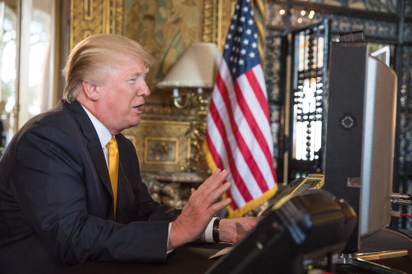 President Donald Trump speaks with members of the armed forces via video conference from the...