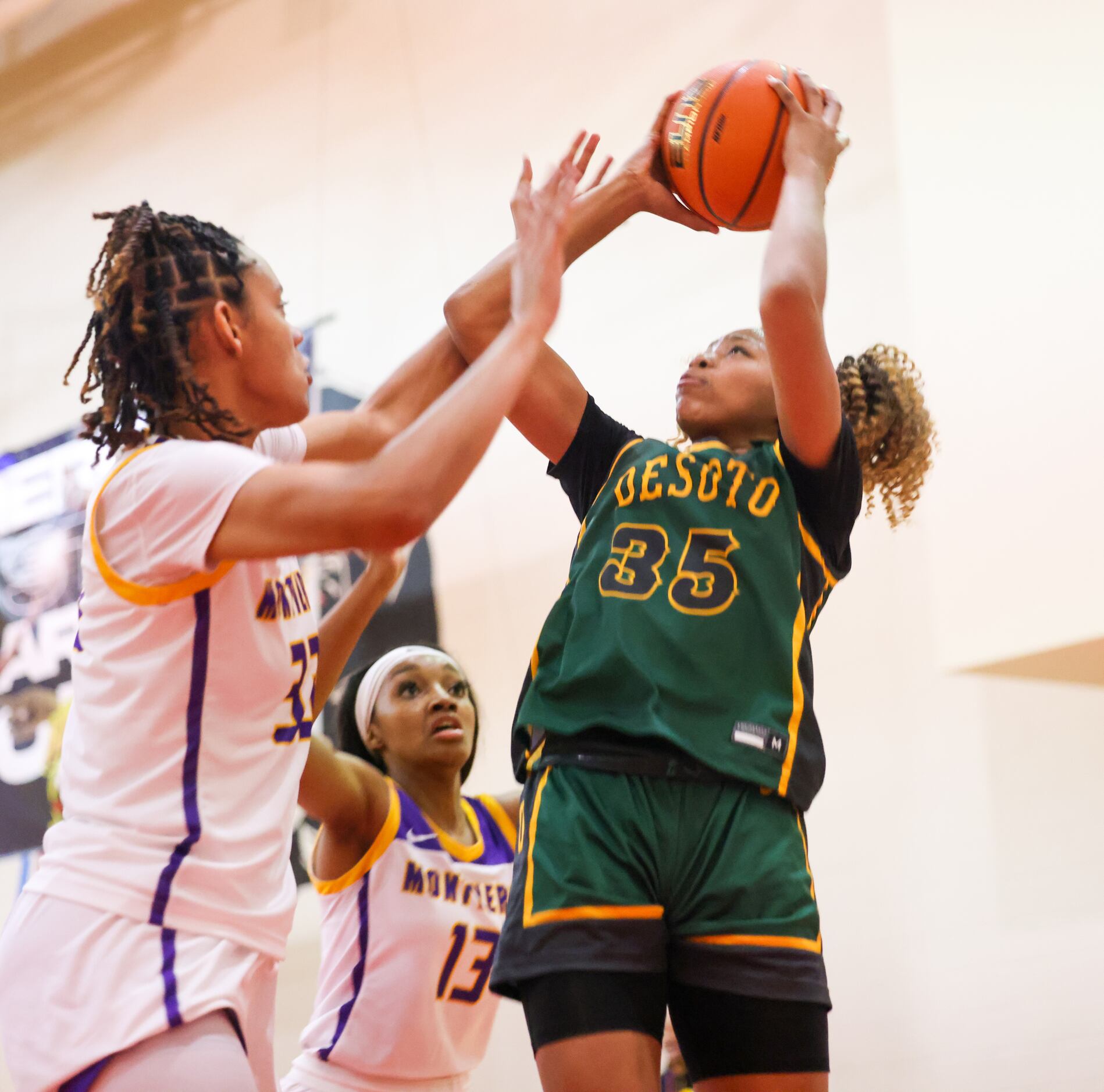 DeSoto’s Dayshauna Crowley (35) attempts a shot with pressure from Montverde Academy Lety...