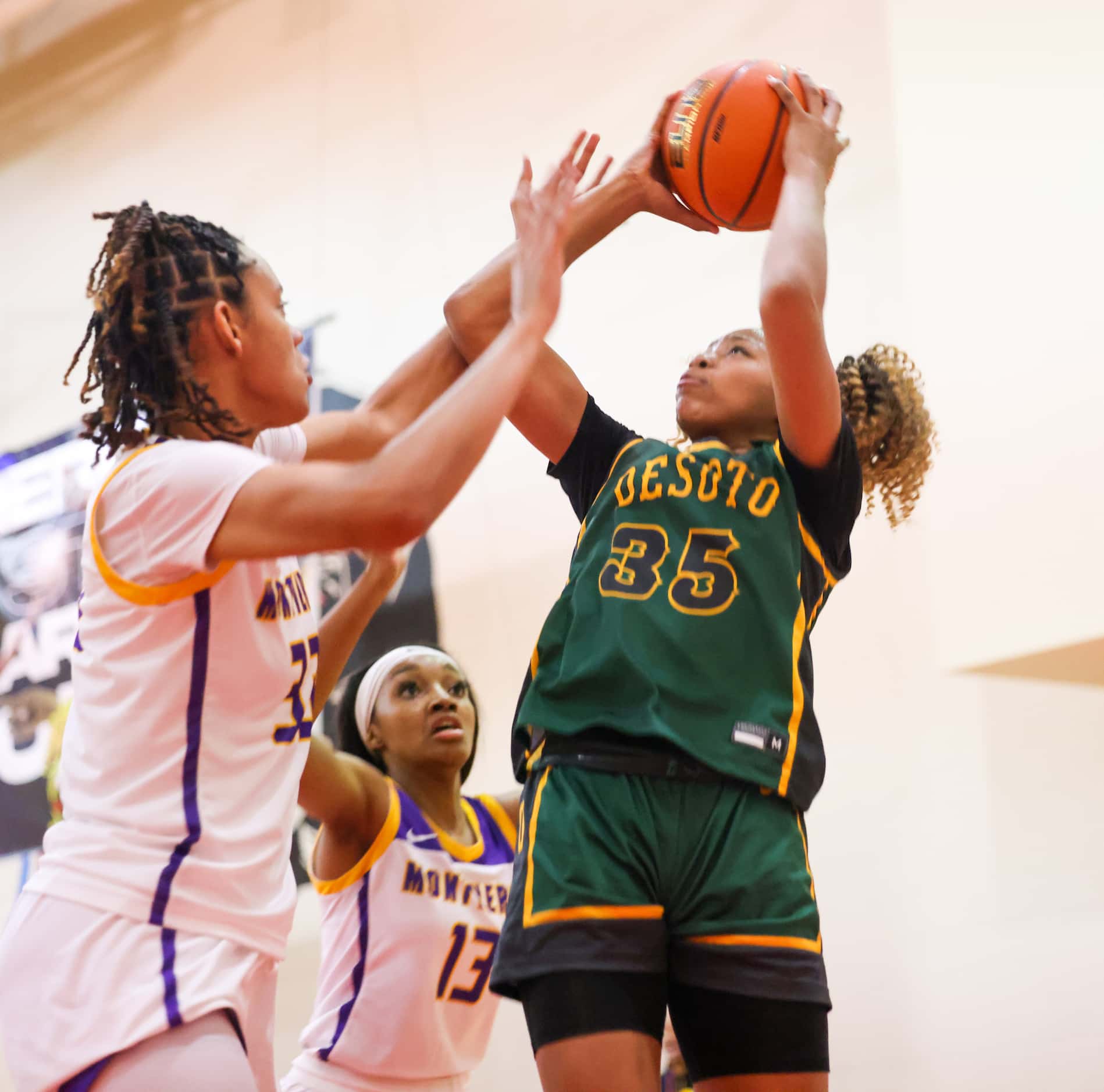 DeSoto’s Dayshauna Crowley (35) attempts a shot with pressure from Montverde Academy Lety...