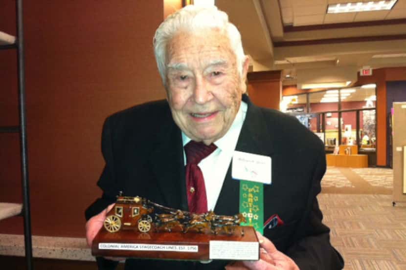 Bill Steele shows off his Colonial America Stagecoach Lines carving at the 2013 Grand...
