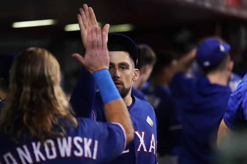 Texas Rangers starting pitcher Nathan Eovaldi, right is congratulated by right fielder...