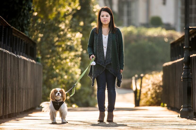 Ebola survivor Nina Pham walks her dog Bentley on Wednesday, Feb. 25, 2015, in Dallas....