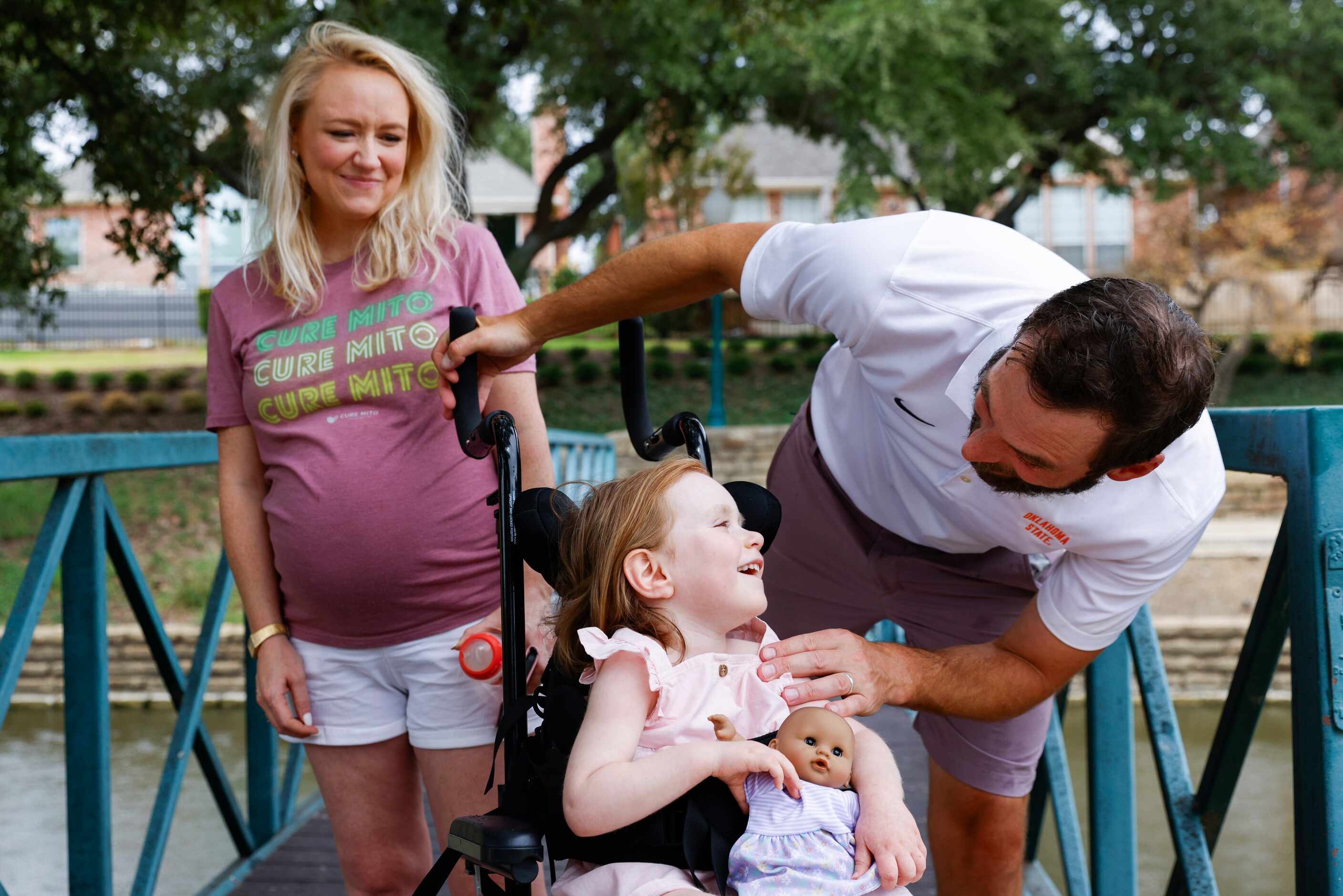 Lauren Ashwin (left) watches as her daughter Delta (center) laughs toward her father Nick in...