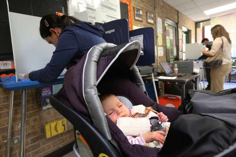 Five-month-old Elinor Smith sleeps though her first presidential election as her mom, Neda...