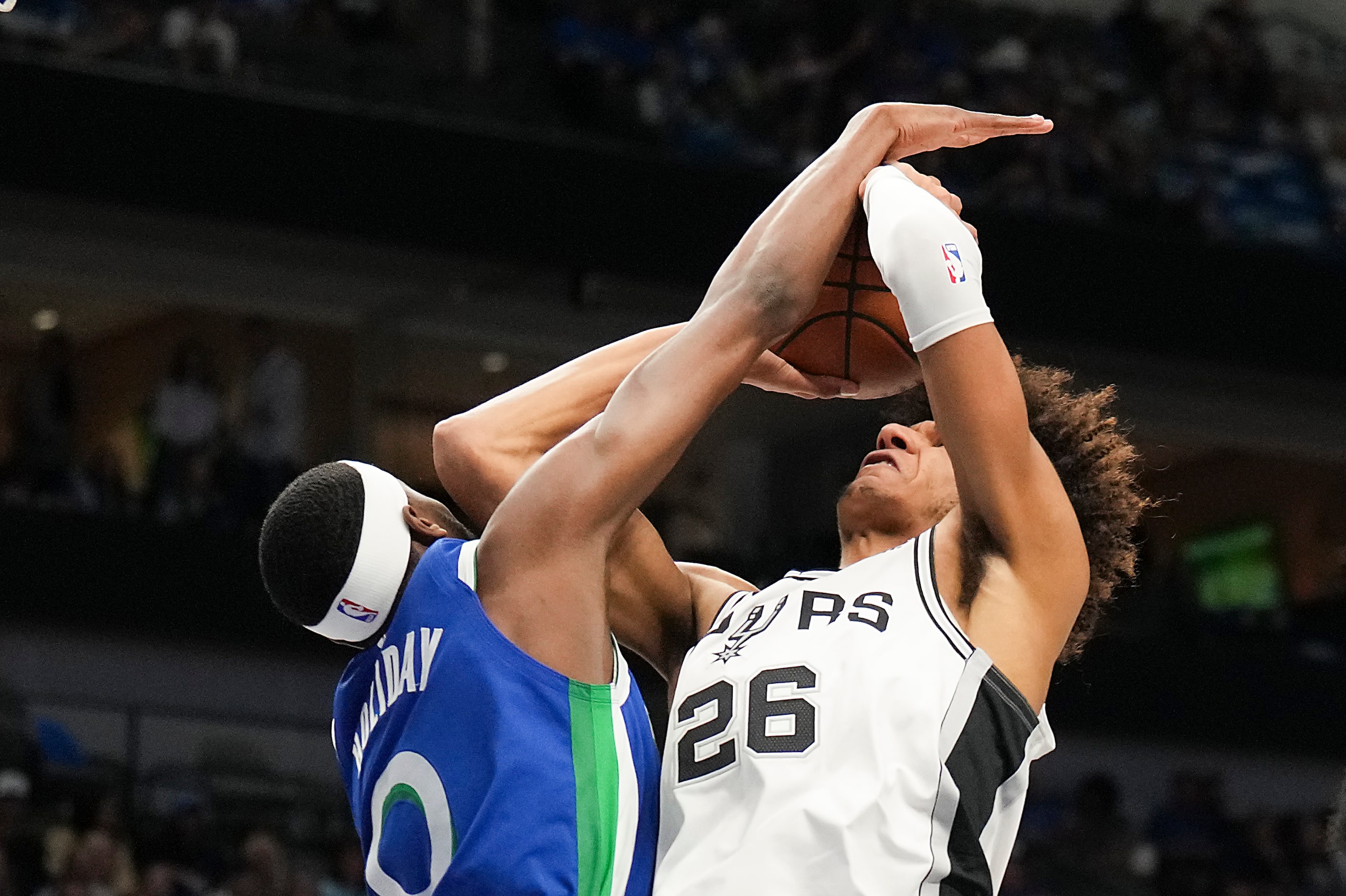 San Antonio Spurs forward Dominick Barlow (26) is fouled by Dallas Mavericks forward Justin...