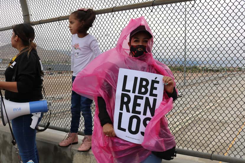 Lourdes Vázquez holds a banner at a demonstration by the Border Network for Human Rights...