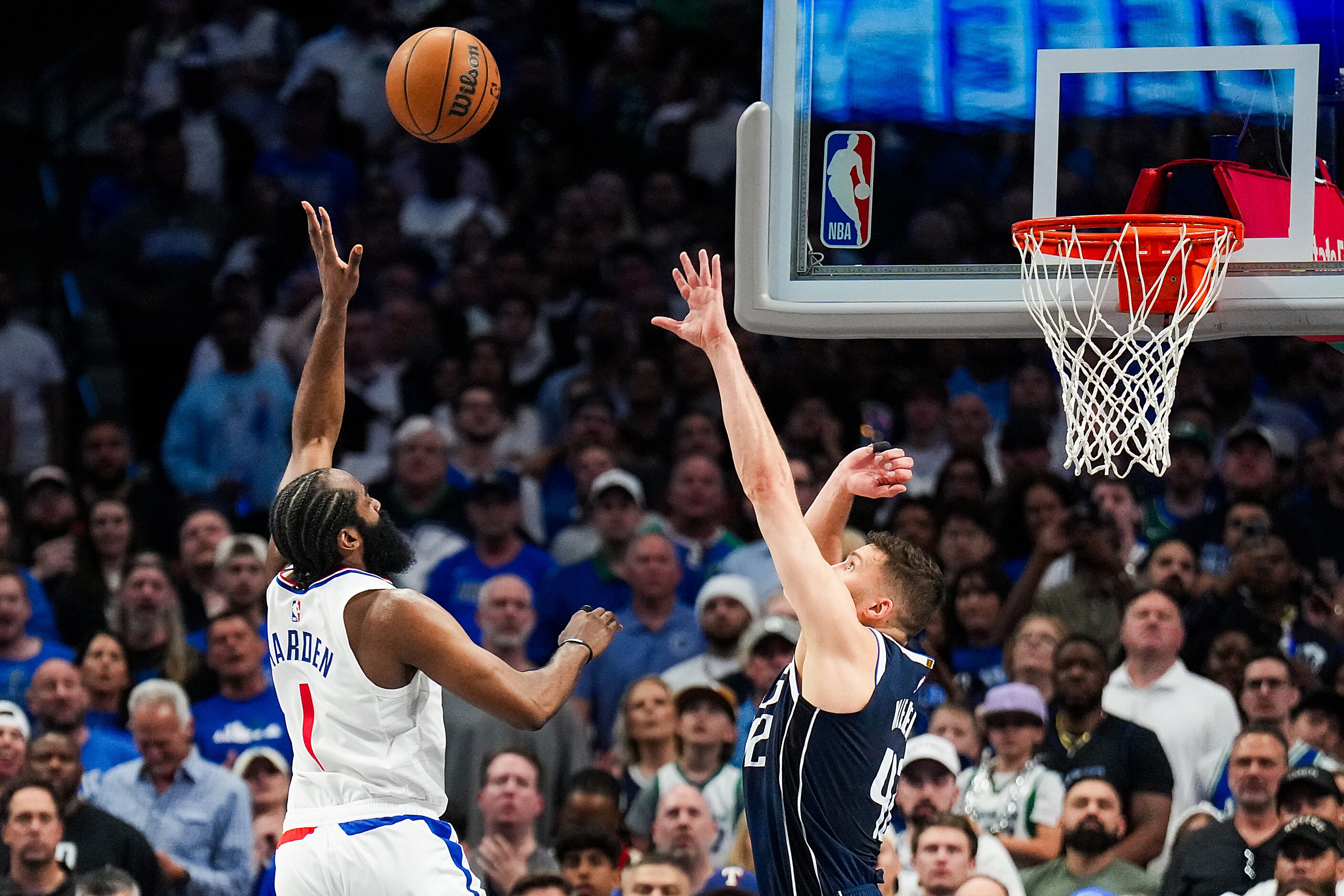 LA Clippers guard James Harden (1) scores on a floater over Dallas Mavericks forward Maxi...