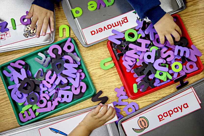Pre-kindergarten elementary students at Caillet Elementary School use letters to spell out...