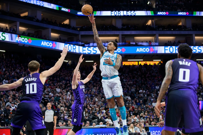 Charlotte Hornets forward P.J. Washington shoots over Sacramento Kings forward Domantas...