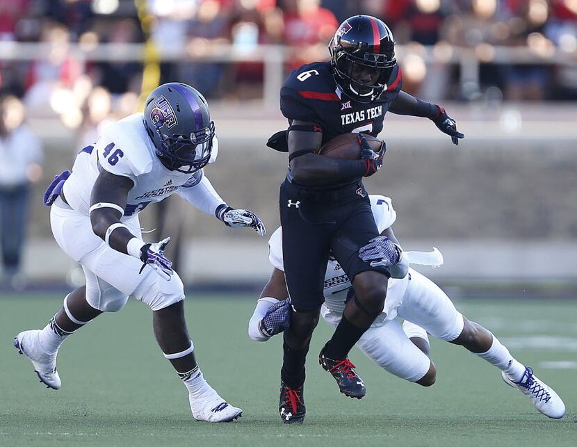 Texas Tech's Devin Lauderdale (6) tries to get past Central Arkansas' Bobby Watkins (7) and...