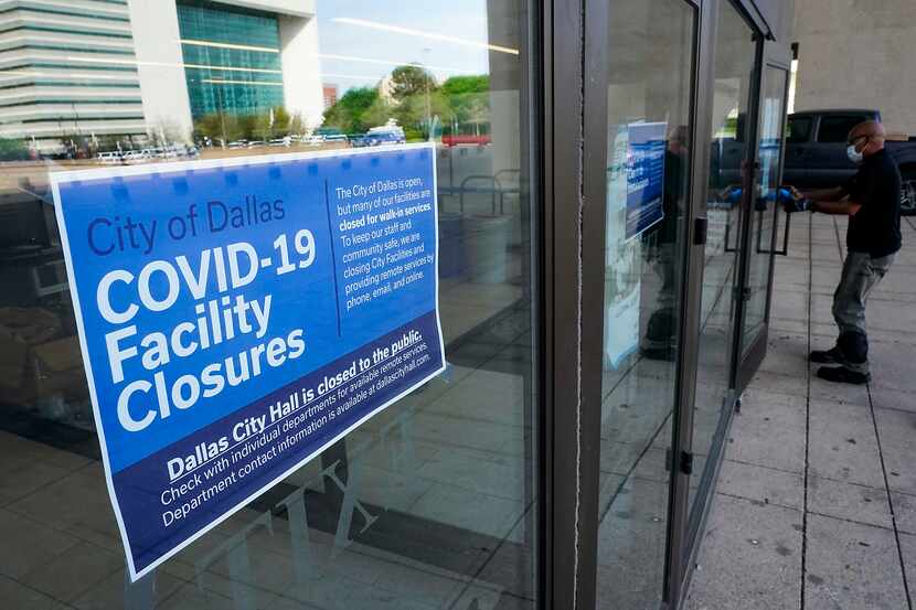 A sign announces the public closure of city facilities at Dallas City Hall on Tuesday, March...