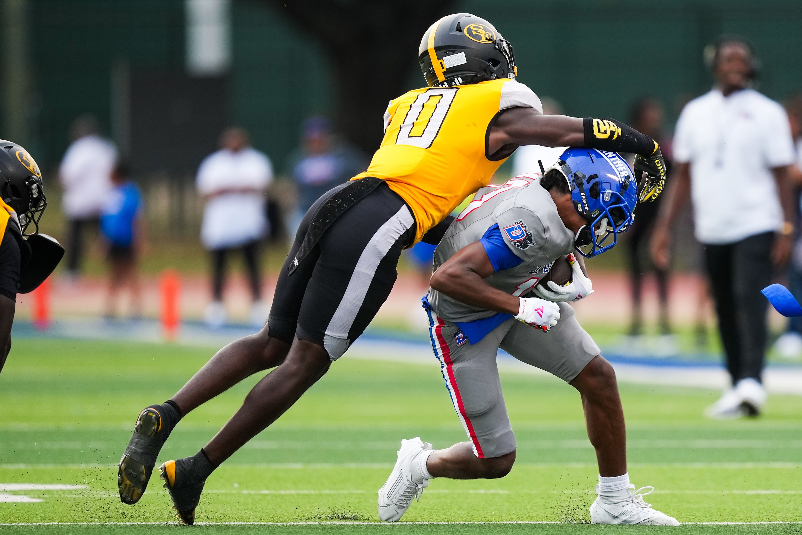 Duncanville wide receiver Emmanuel Ellison (13) is brought down by St. Frances Academy...