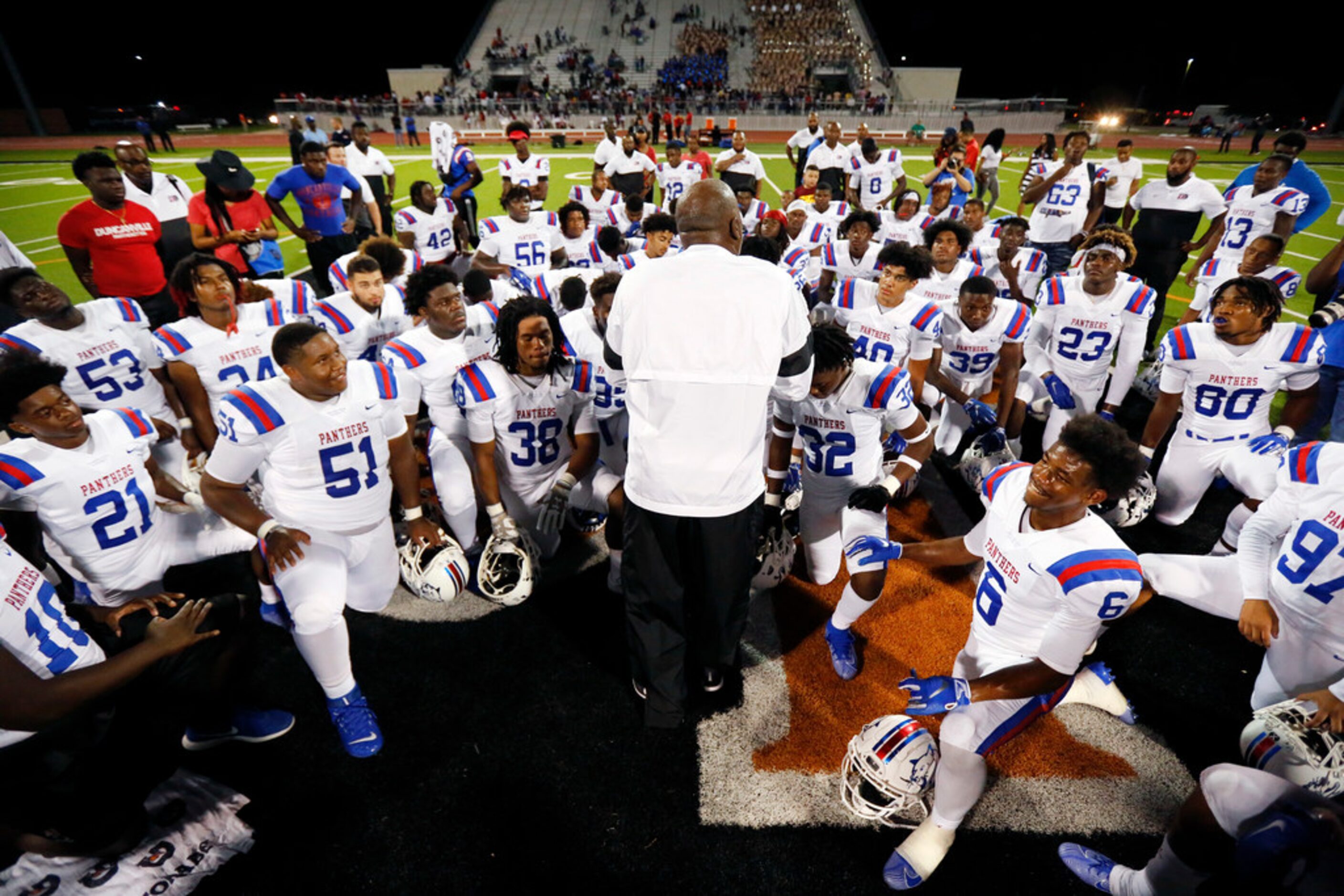 Duncanville head coach Reginald Samples gathers his players together for a postgame huddle...