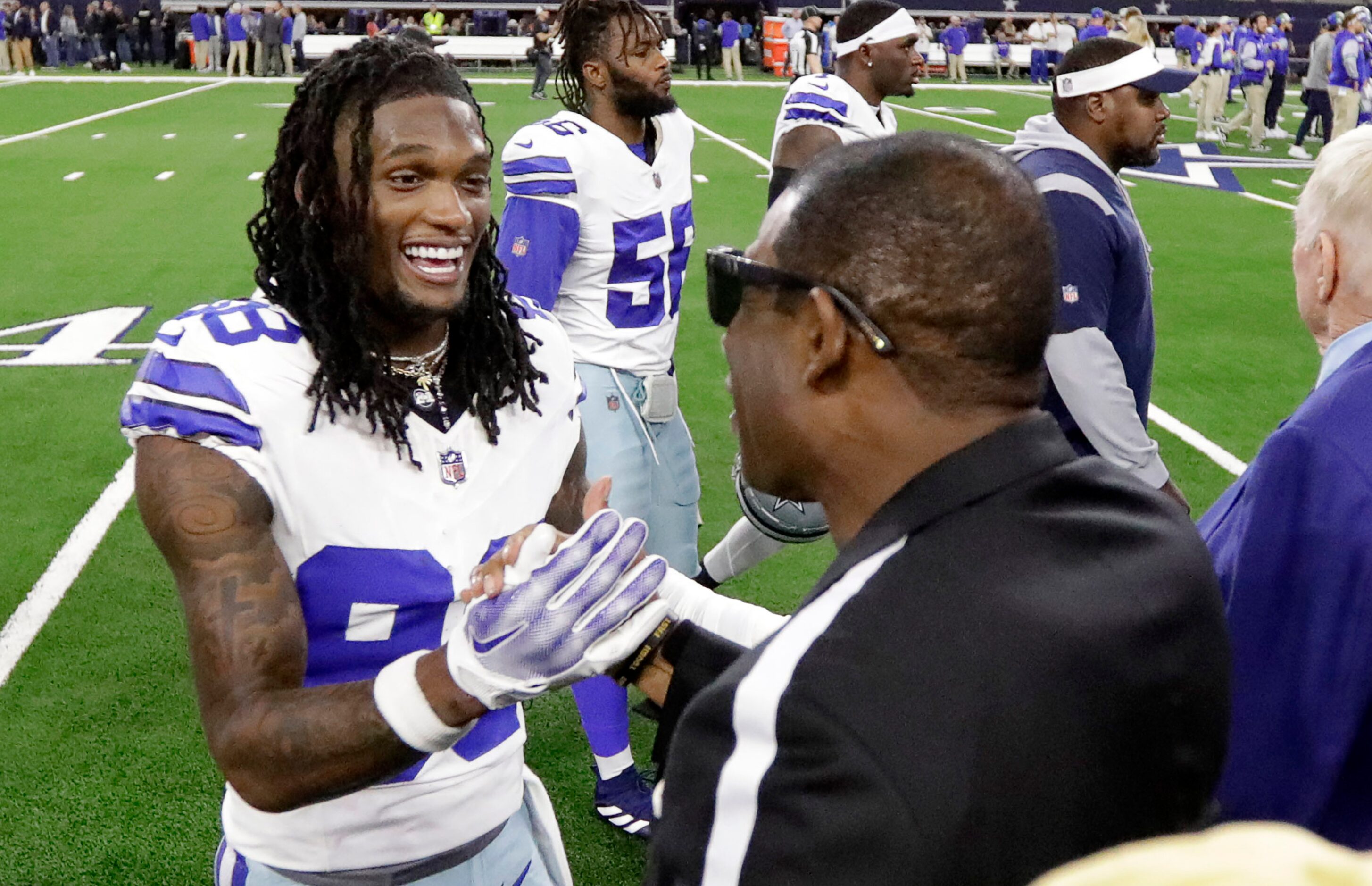 Former Dallas Cowboys player and current University of Colorado coach Deion Sanders  (right)...