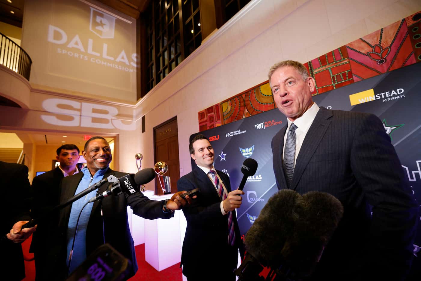 Pro Football Hall of Famer Troy Aikman, right, talks to reporters on the red carpet during a...