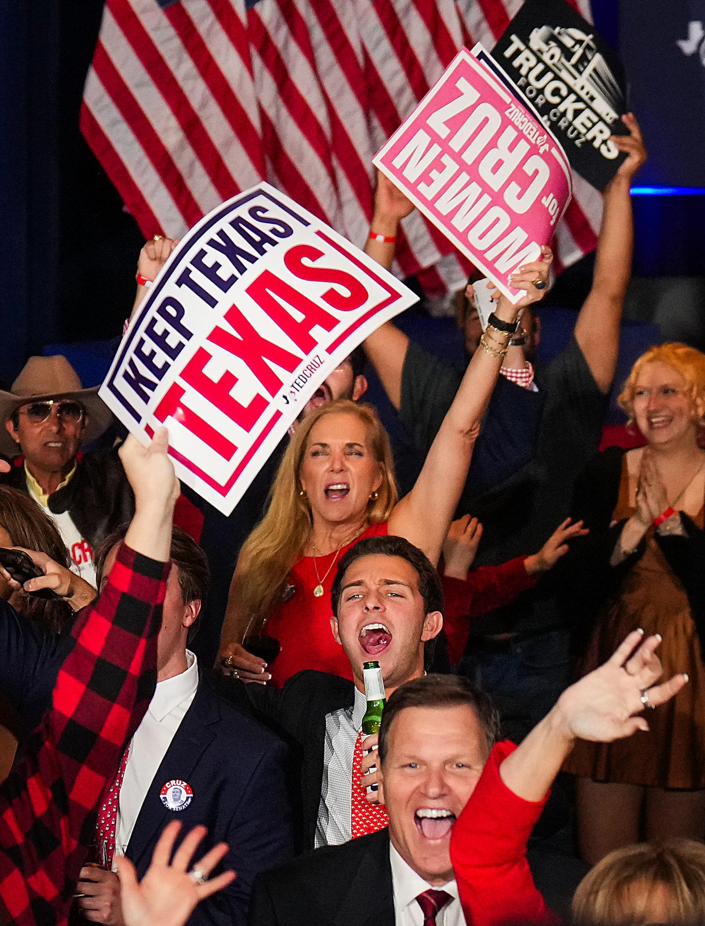 Supporters celebrate as Fox News calls the election for their candidate during an election...