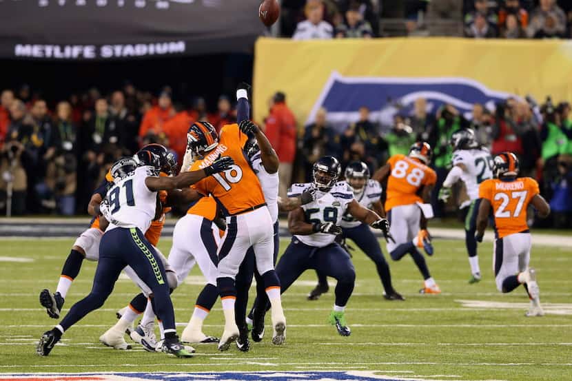 Quarterback Peyton Manning #18 of the Denver Broncos throws an interception during the...