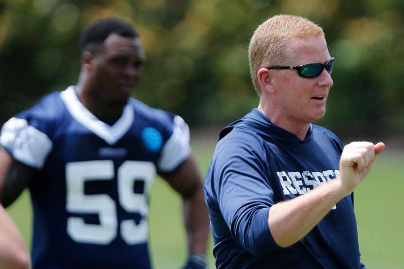 Cowboys head coach Jason Garrett gives instruction as the Dallas Cowboys held their rookie...