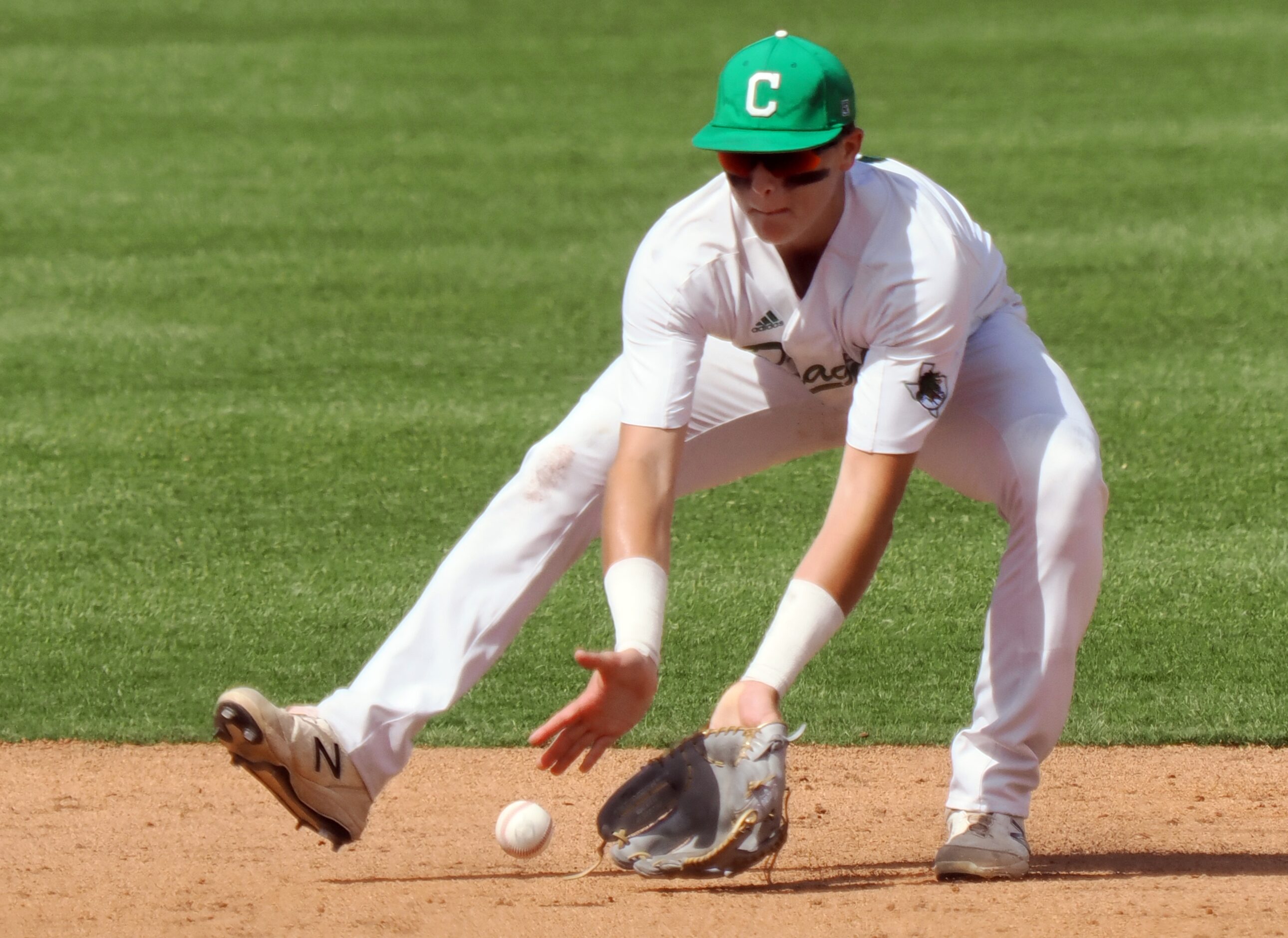 Southlake Carroll secnond baseman Ben Tryon (8) scoops up a grounder against San Antonio...