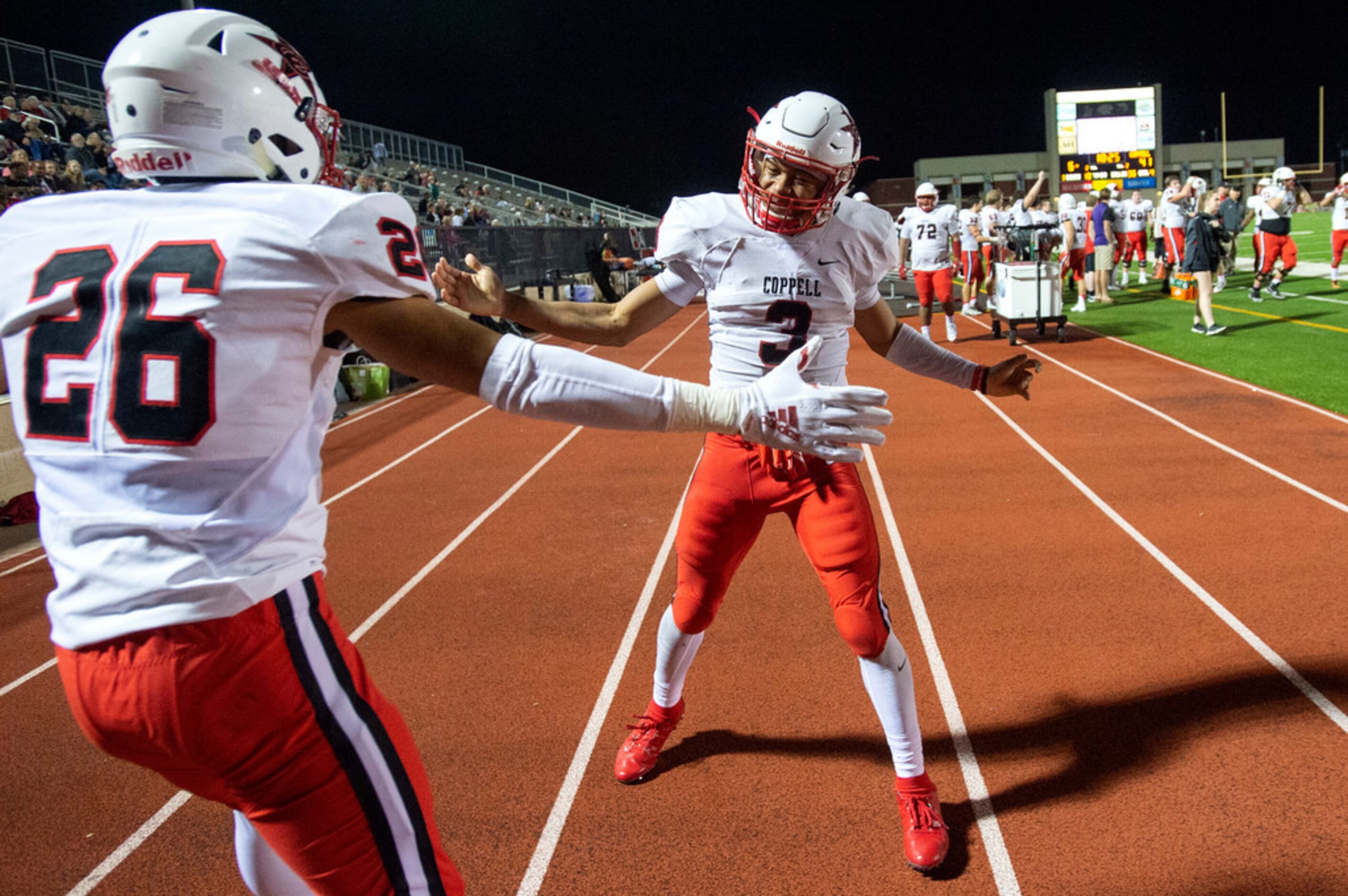 Coppell senior defensive back Jonathan McGill (3) celebrates with senior defensive back Noah...