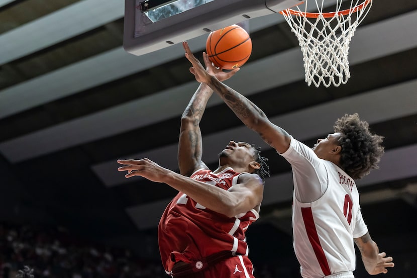 Oklahoma forward Jalon Moore (14) shoots past Alabama guard Labaron Philon (0) during the...