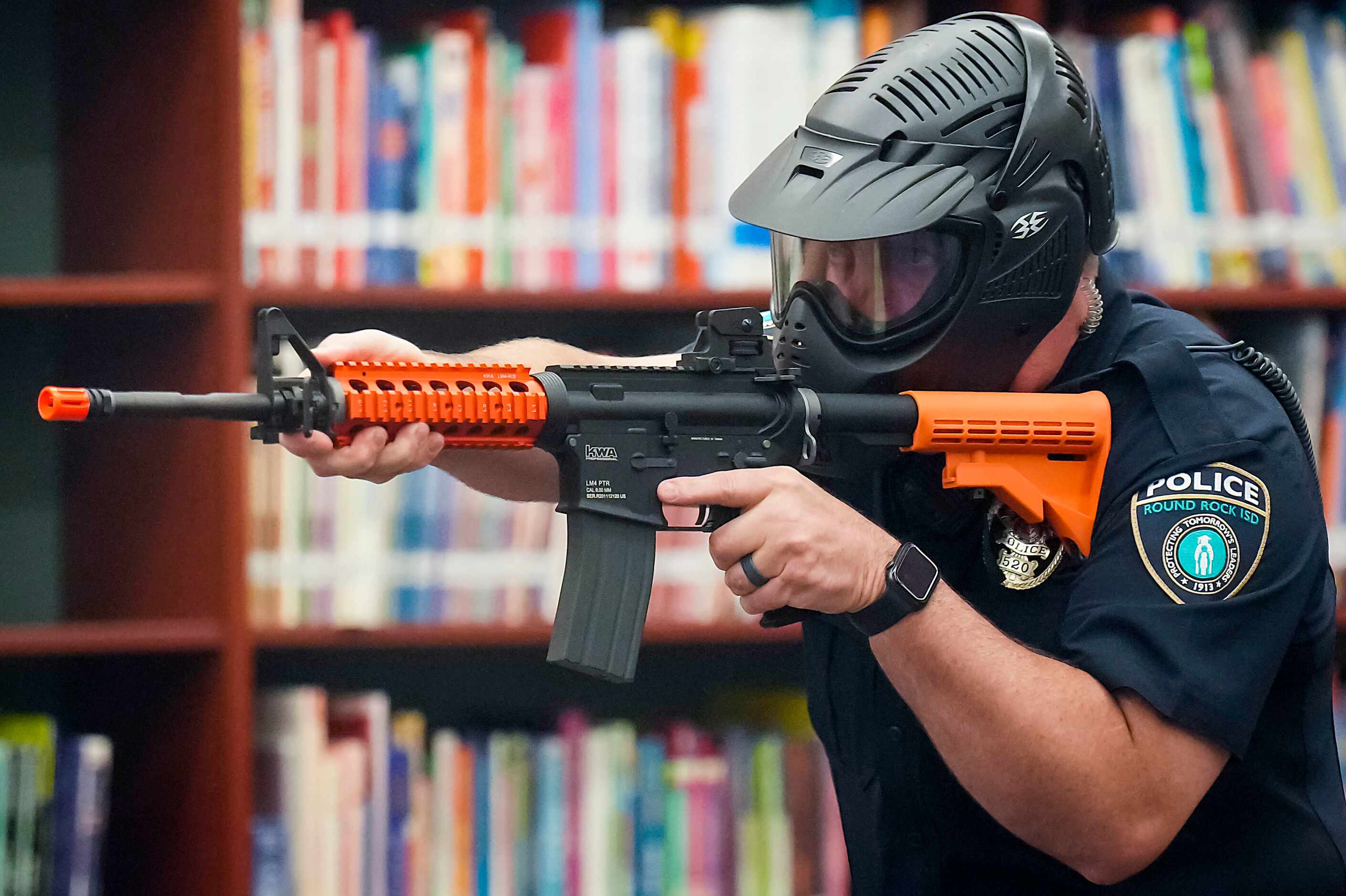 Round Rock ISD police officer Aaron Grigsby participates in a school safety active shooter...
