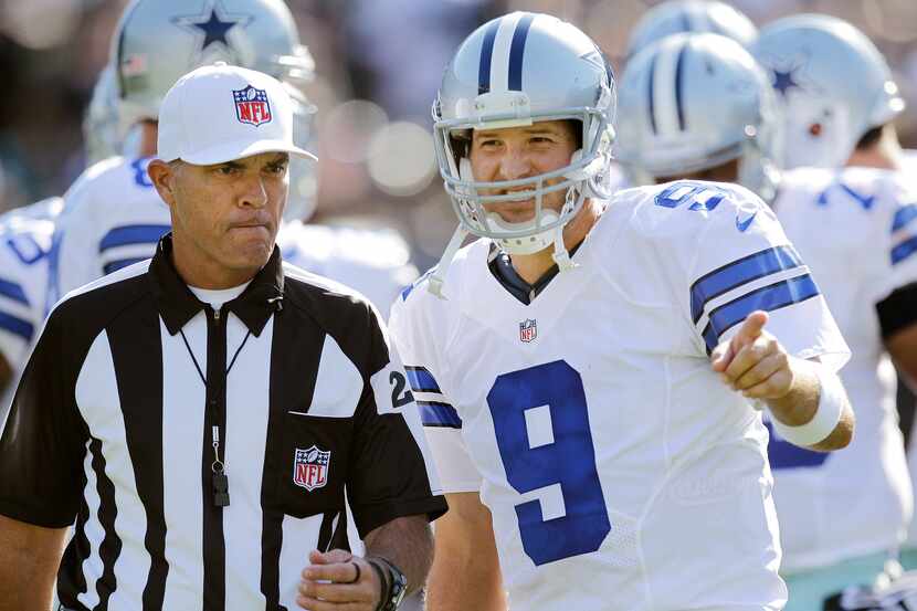 Dallas Cowboys quarterback Tony Romo (9) talks with an official during the first quarter of...