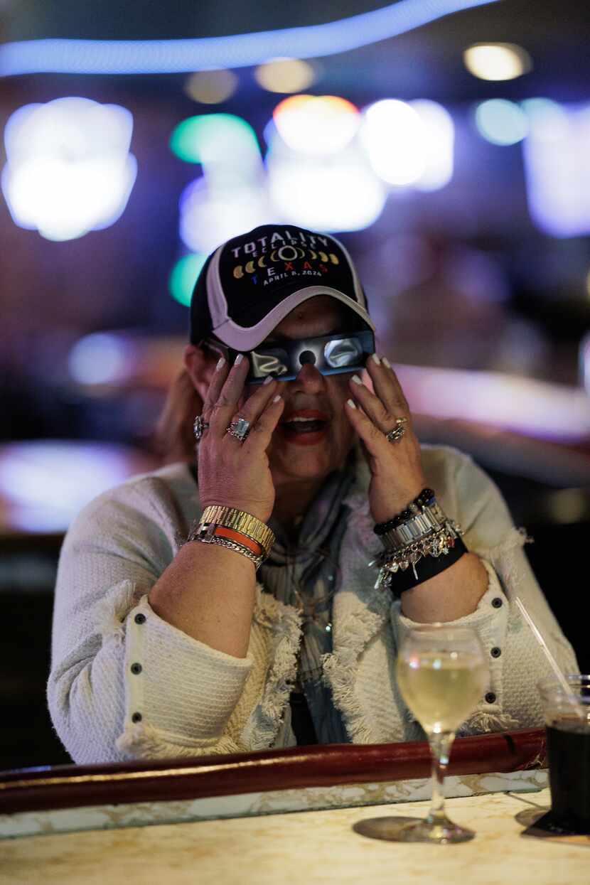 Sandy Pomeroy tries on her eclispe glass before the total eclipse at The Goat in Dallas on...