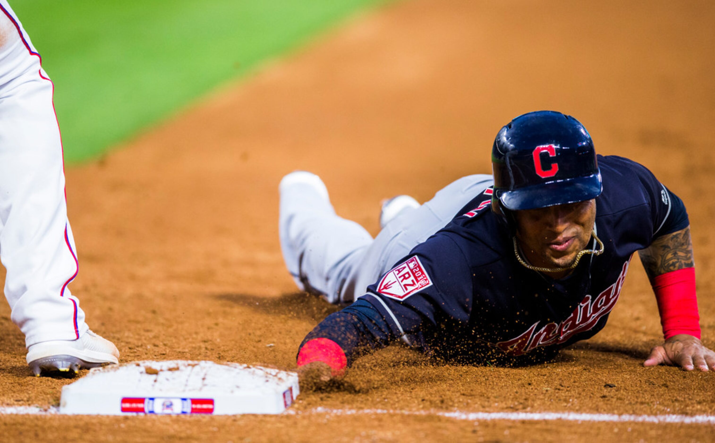 Cleveland Indians designated hitter Hanley Ramirez (2) makes it safely back to first base...