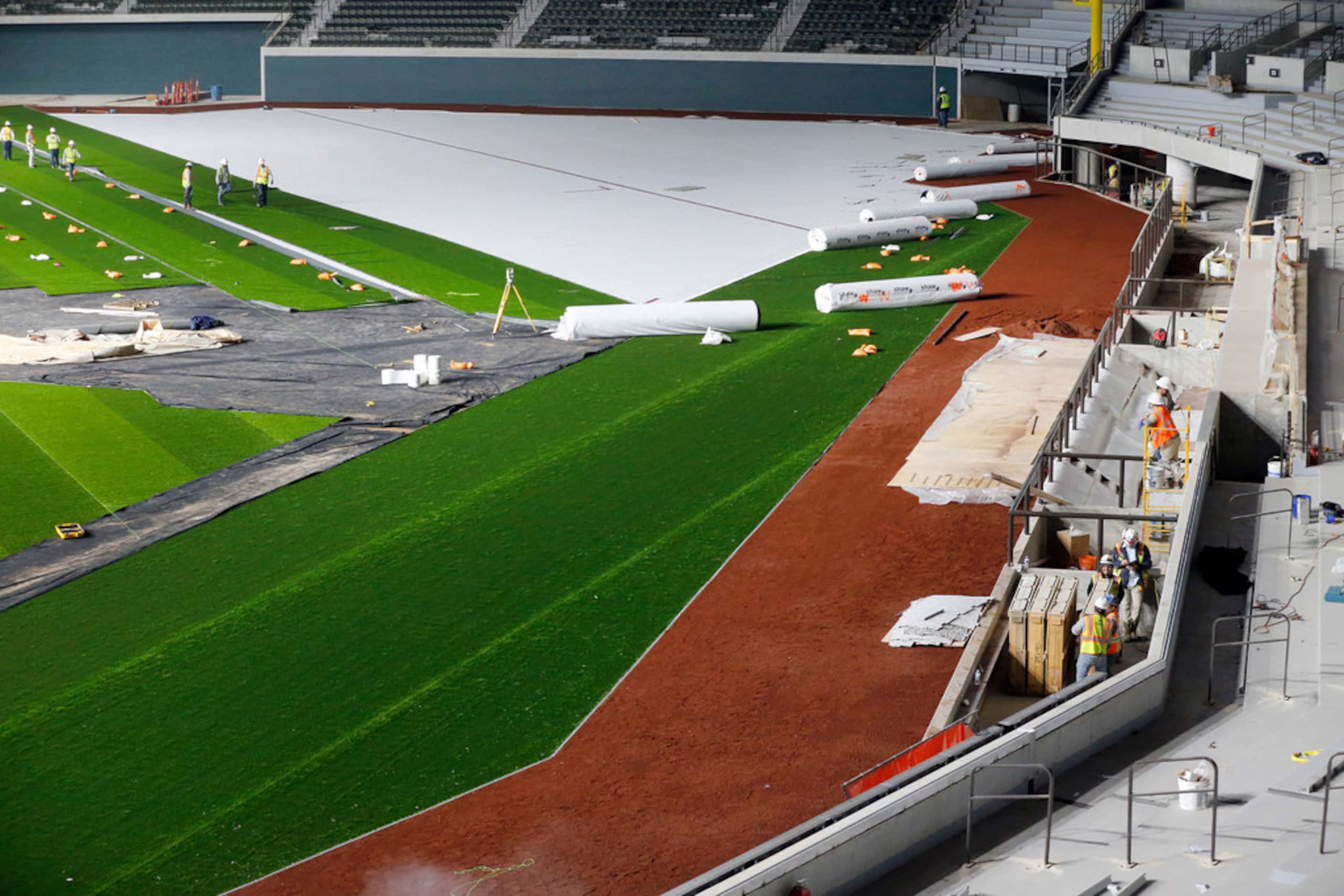 The synthetic grass by Shaw Sports Turf and infield dirt are being installed at Globe Life...