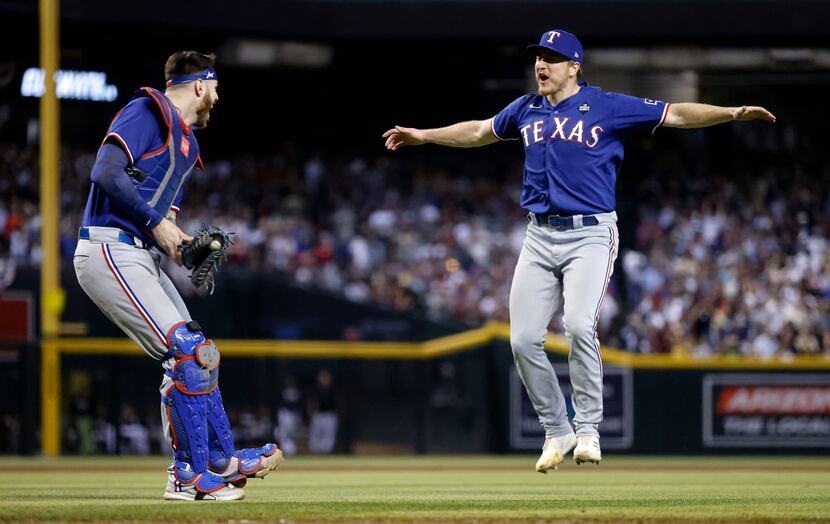 Texas Rangers relief pitcher Josh Sborz (right) and catcher Jonah Heim (28) celebrate their...