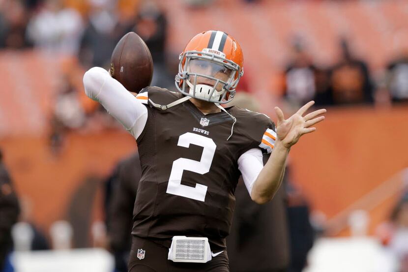 FILE - In this Dec. 14, 2014 file photo, Cleveland Browns quarterback Johnny Manziel warms...