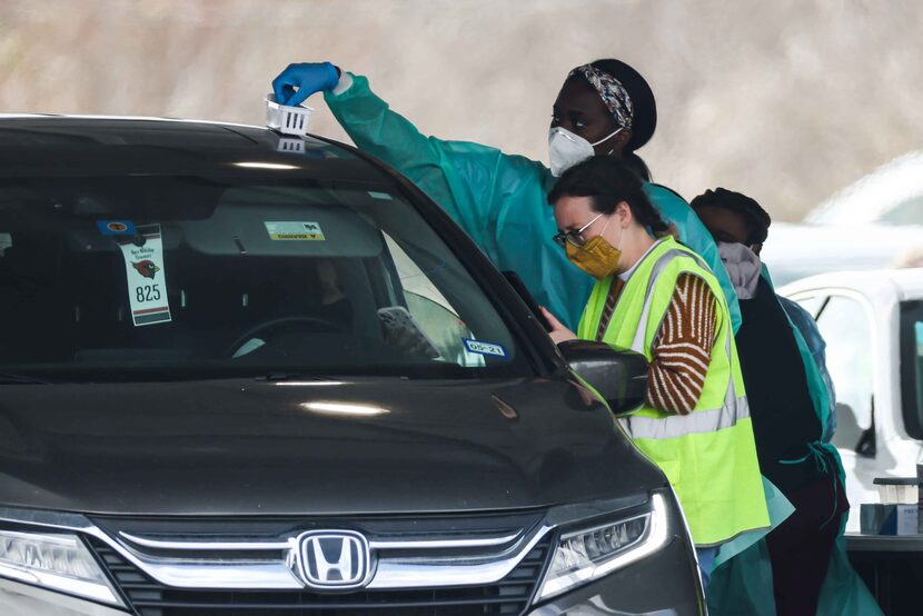 Dallas County staff, with support from FEMA and Army medics, administer doses of Pfizer,...